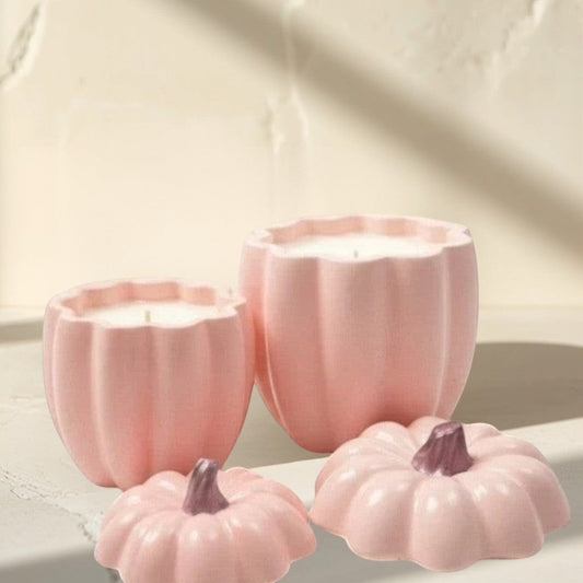 Doodlations Coffee Bar & Boutique pink concrete pumpkin candles in two sizes with removable lids.