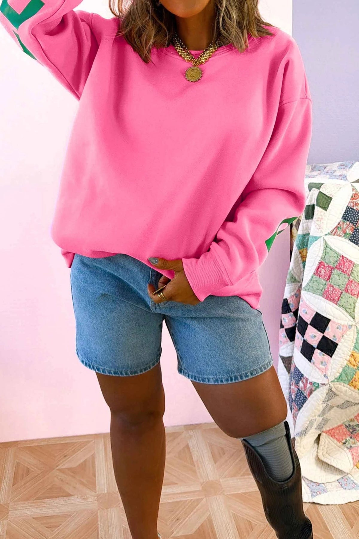 Doodlations Coffee Bar & Boutique pink long sleeve sweatshirt with round neck and slogan print worn with denim shorts