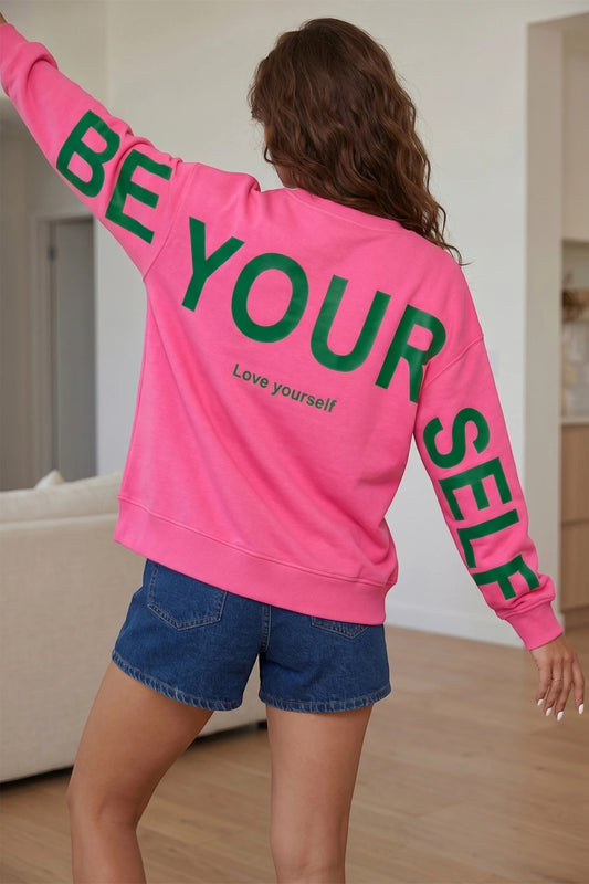 Doodlations Coffee Bar & Boutique pink long sleeve sweatshirt with green Be Yourself slogan print on back and sleeves