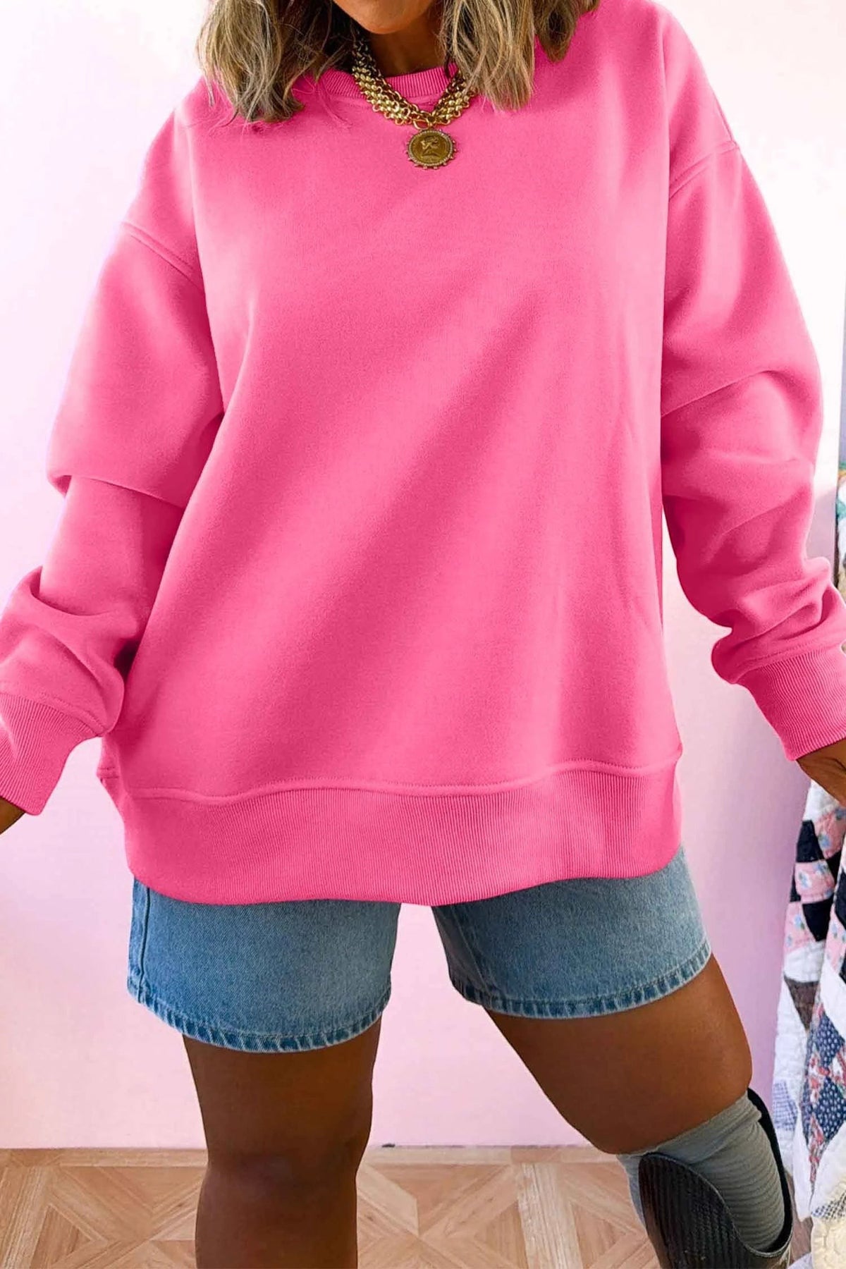 Doodlations Coffee Bar & Boutique bright pink round neck long sleeve sweatshirt worn with denim shorts
