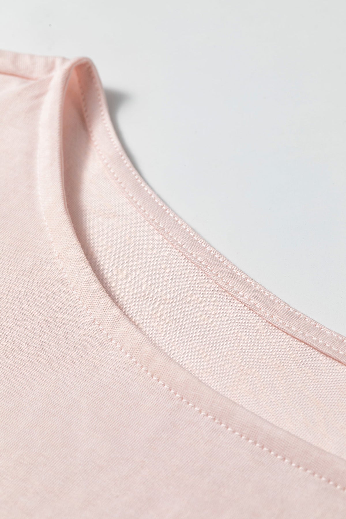 Doodlations Coffee Bar & Boutique baby pink long sleeve top with a soft round neckline and delicate stitching detail.