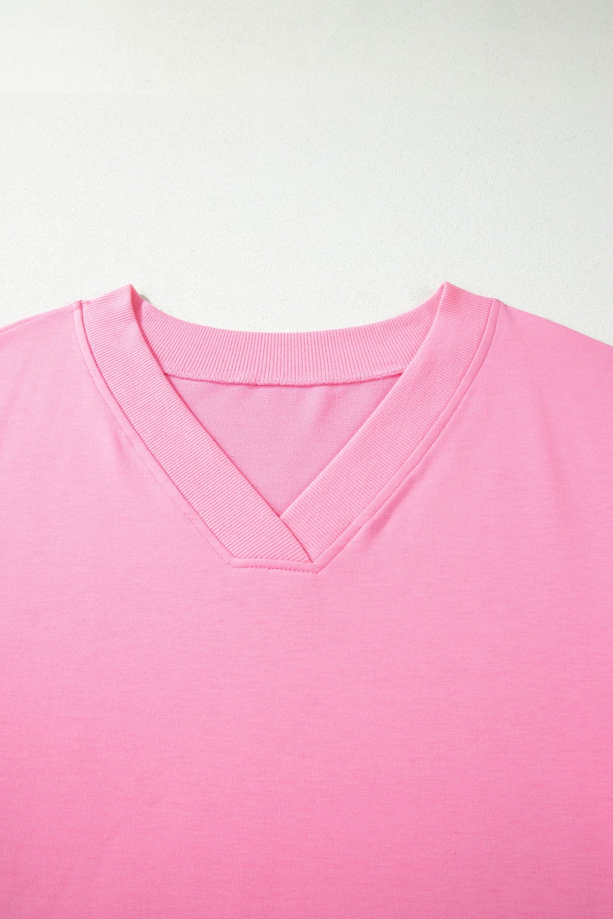 Doodlations Coffee Bar & Boutique pink solid V-neck tee with ribbed neckline detail