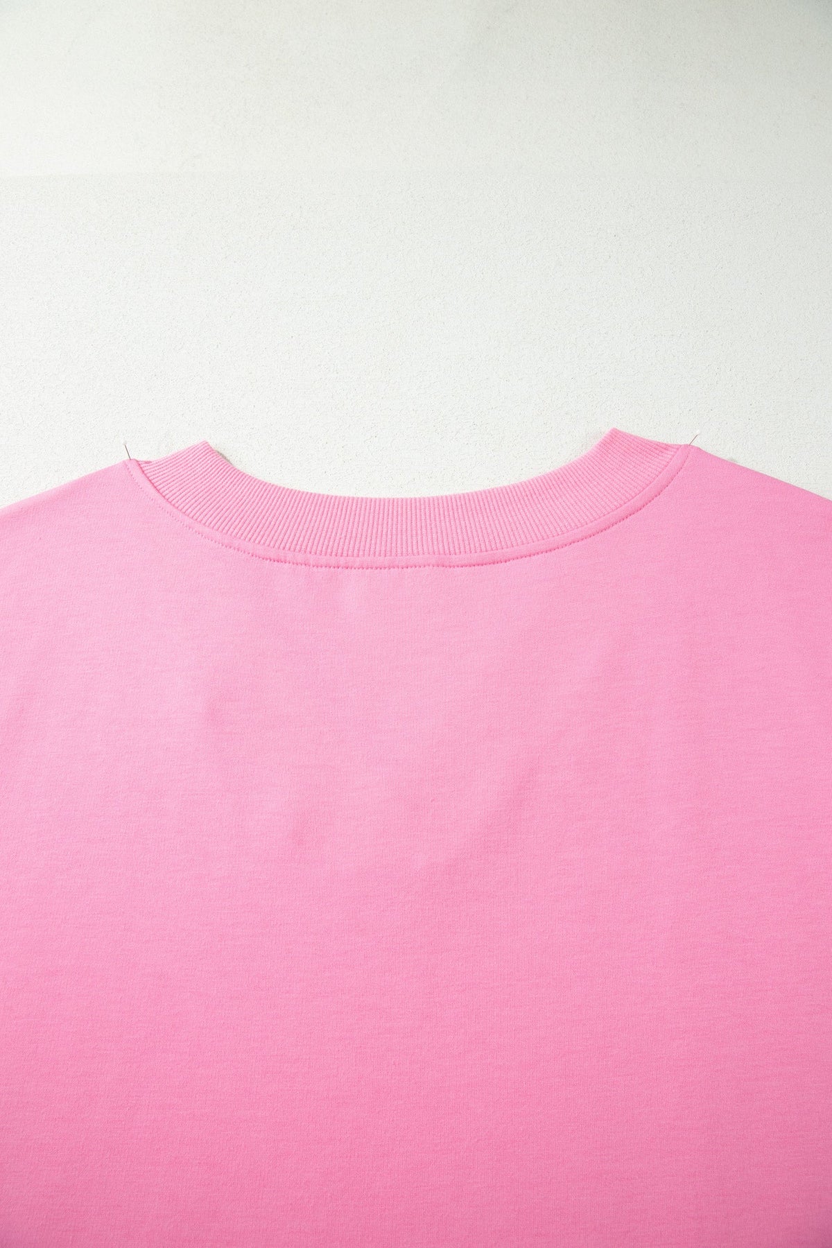 Doodlations Coffee Bar & Boutique pink solid V-neck tee featuring a ribbed neckline detail