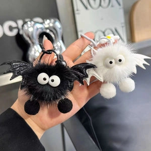 Doodlations Coffee Bar & Boutique plush bat bag charms in black and white faux fur with googly eyes and wings