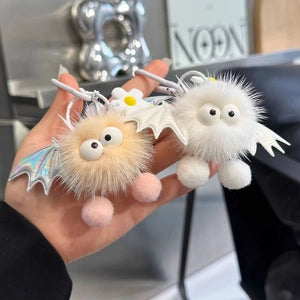 Doodlations Coffee Bar & Boutique plush bat bag charms in beige and white with holographic wings and googly eyes