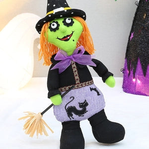 Doodlations Coffee Bar & Boutique witch plush doll ornament with orange hair, black hat, and a miniature broomstick.