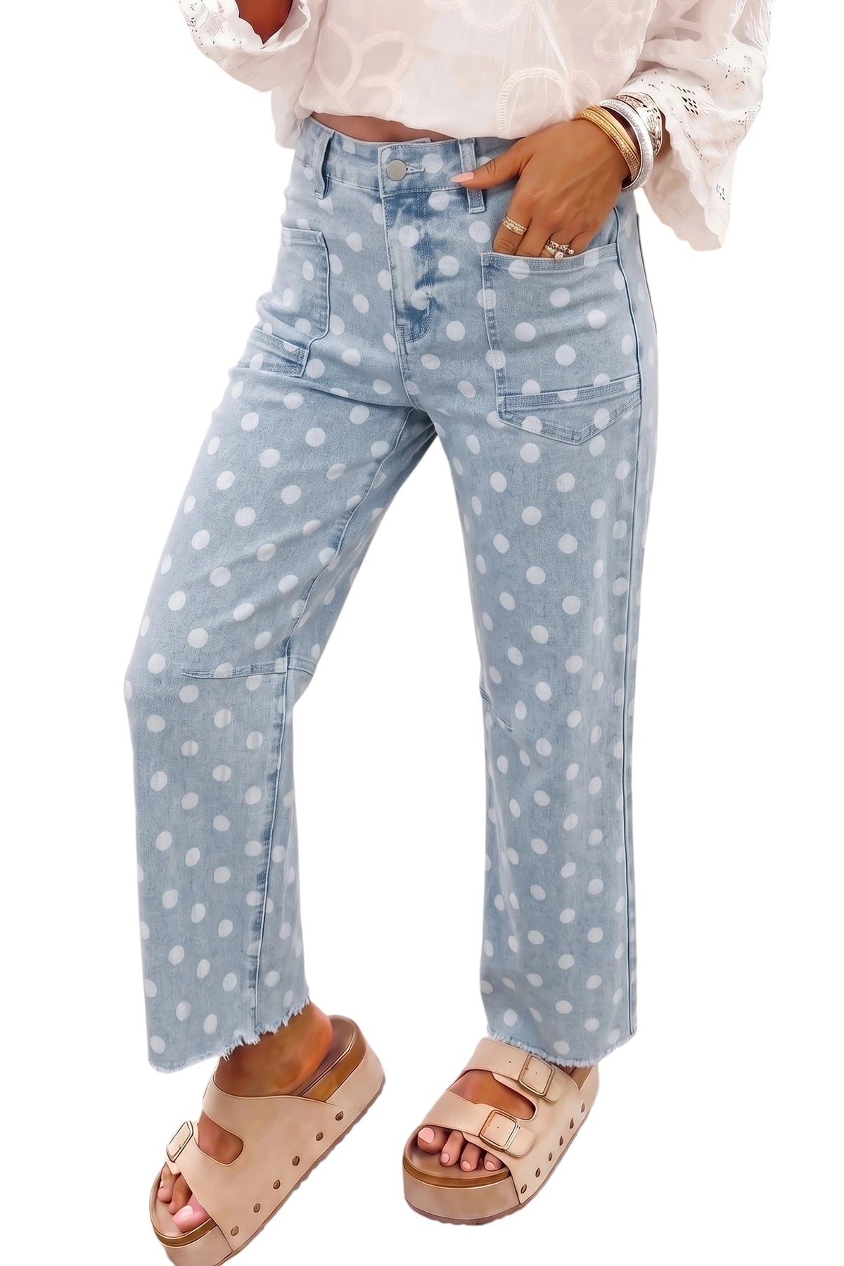 Doodlations Coffee Bar & Boutique sky blue denim jeans with white polka dots, slim fit, and raw hem detail.