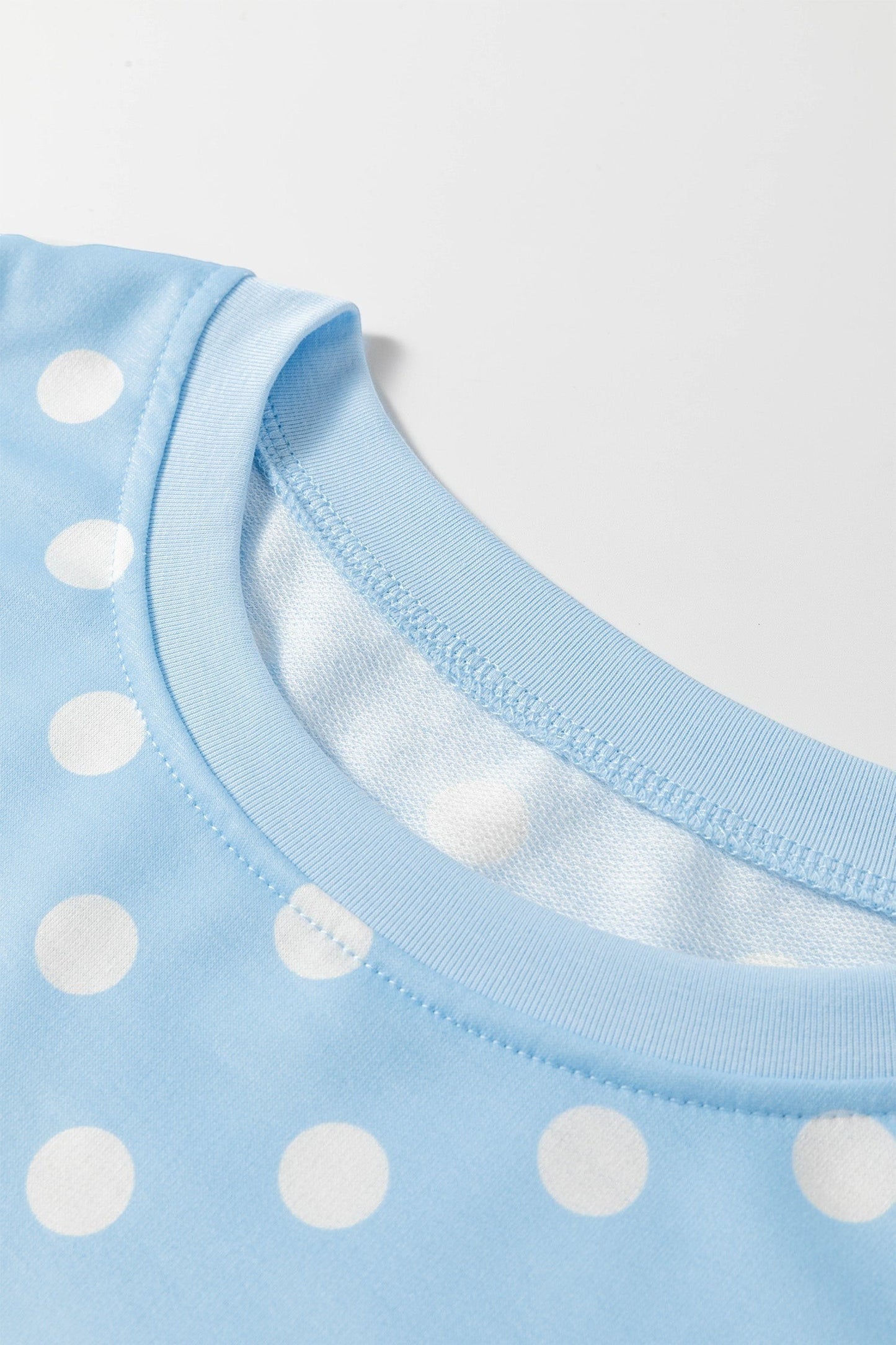 Doodlations Coffee Bar & Boutique light blue lounge set top with white polka dots and a comfortable crew neckline