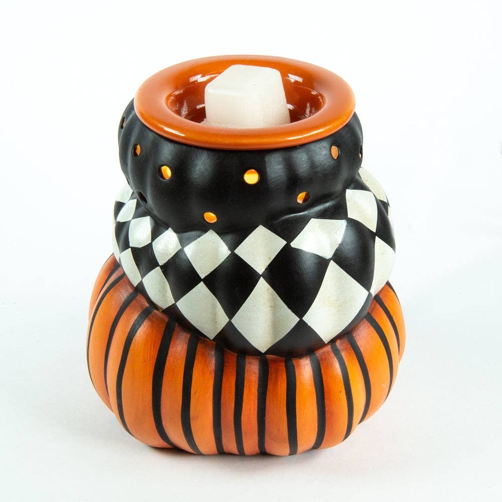Doodlations Coffee Bar & Boutique ceramic pumpkin wax warmer with black, orange, and harlequin diamond patterns.