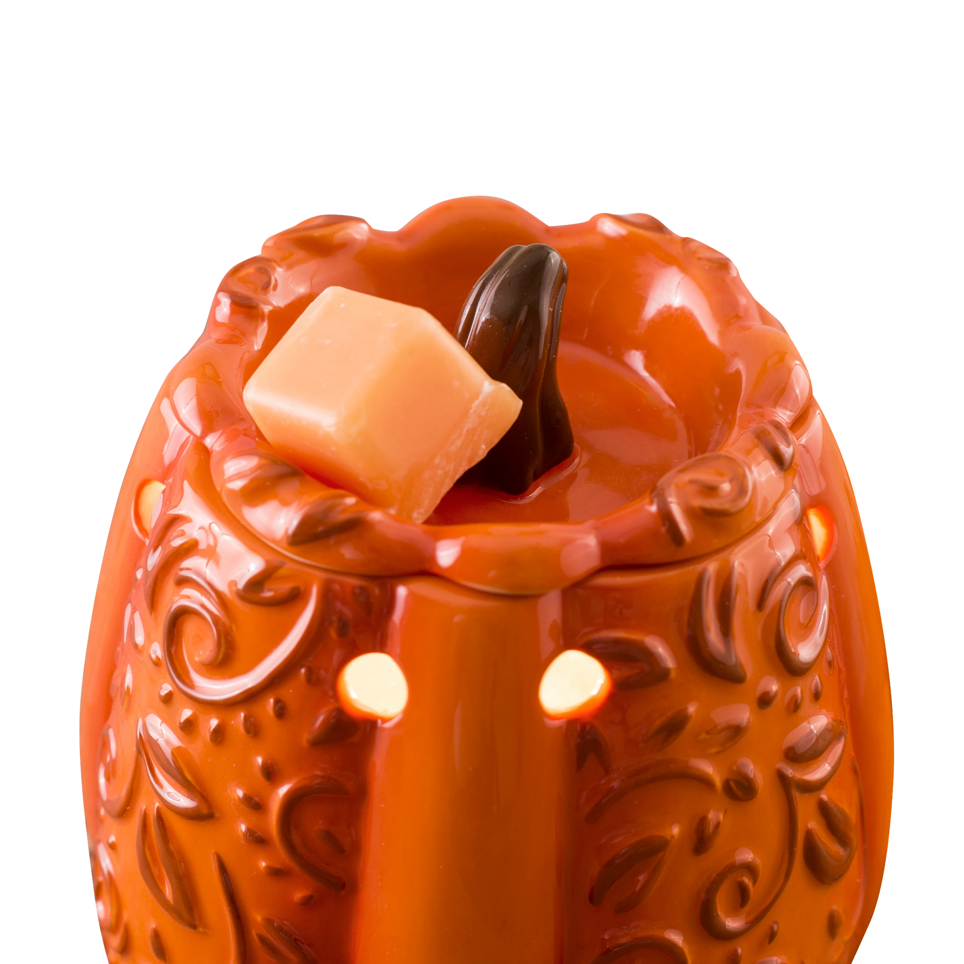 Doodlations Coffee Bar & Boutique orange ceramic pumpkin wax warmer with embossed scrollwork and glowing cutouts
