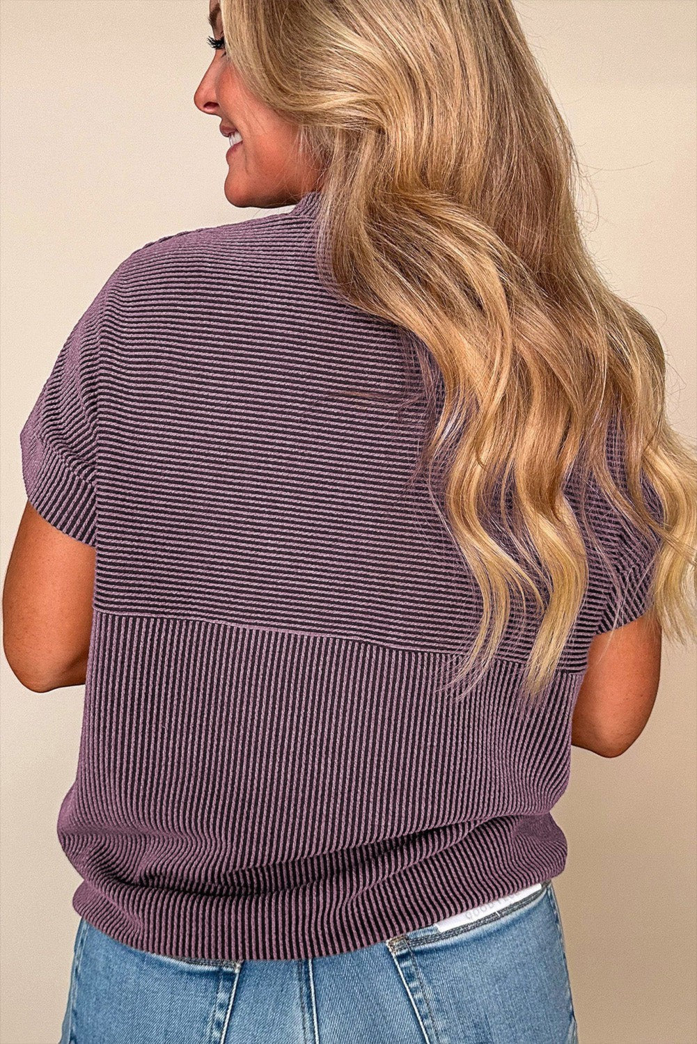 Doodlations Coffee Bar & Boutique purple corded mock neck short sleeve knit top worn by a woman from behind