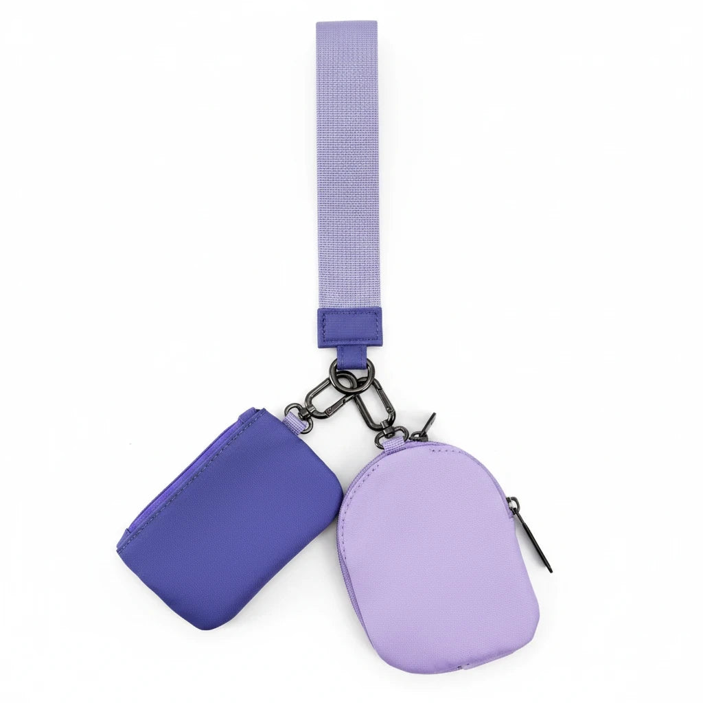 Doodlations Coffee Bar & Boutique Lulu Mac double pouch wristlet in purple and lavender with a matching wrist strap.