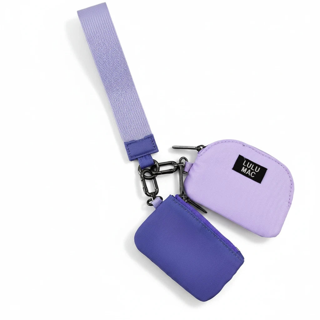 Doodlations Coffee Bar & Boutique Lulu Mac double pouch wristlet in purple and lavender with a matching wrist strap.