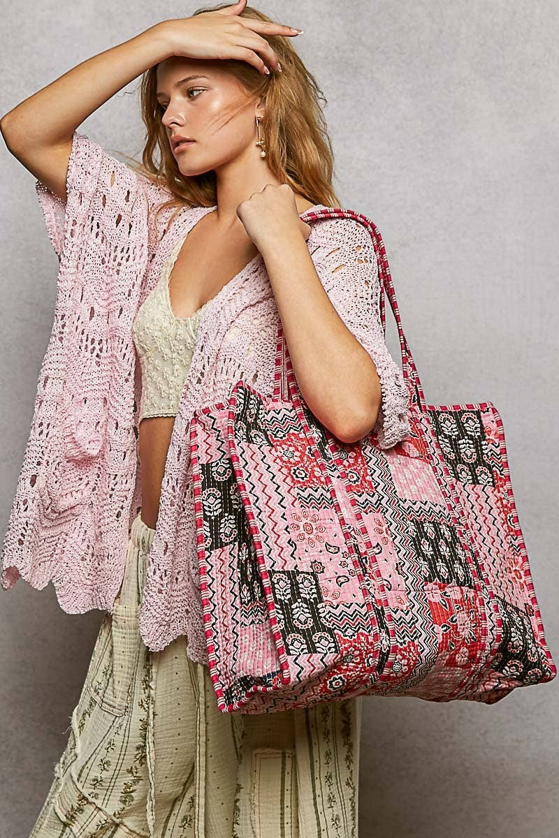 Doodlations Coffee Bar & Boutique quilted woven bohemian tote bag with pink patterned fabric and striped handles.