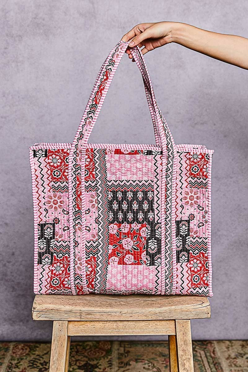 Doodlations Coffee Bar & Boutique quilted woven tote bag in pink, red, and black bohemian patchwork print