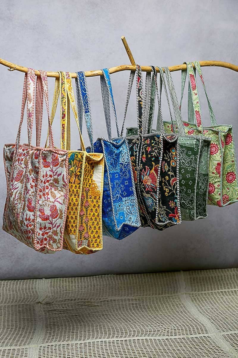 Doodlations Coffee Bar & Boutique quilted tote bags in various floral prints and colours with striped binding accents.