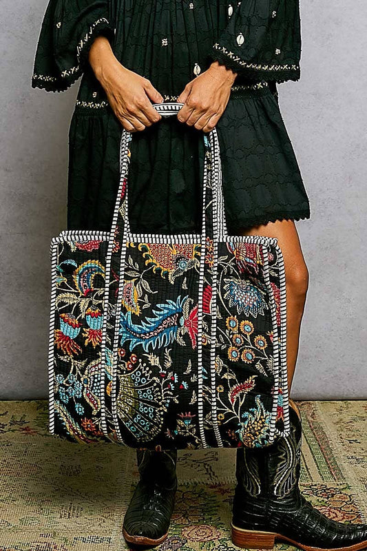 Doodlations Coffee Bar & Boutique black quilted tote bag with colorful floral print and striped binding accents.