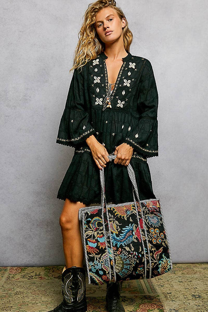 Doodlations Coffee Bar & Boutique black quilted tote bag with vibrant floral print and striped binding trim.