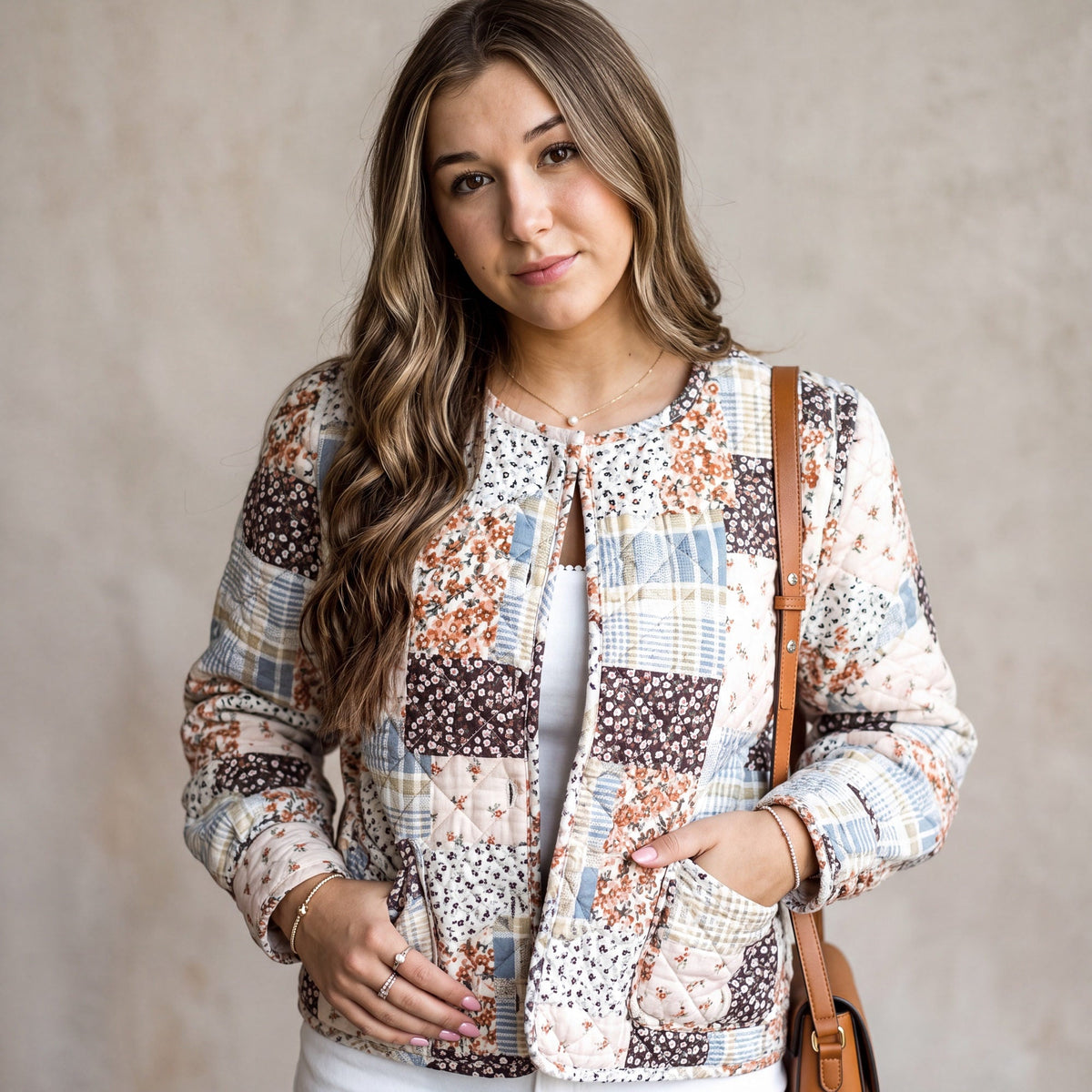 Doodlations Coffee Bar & Boutique quilted patchwork jacket with floral prints and button front on a woman