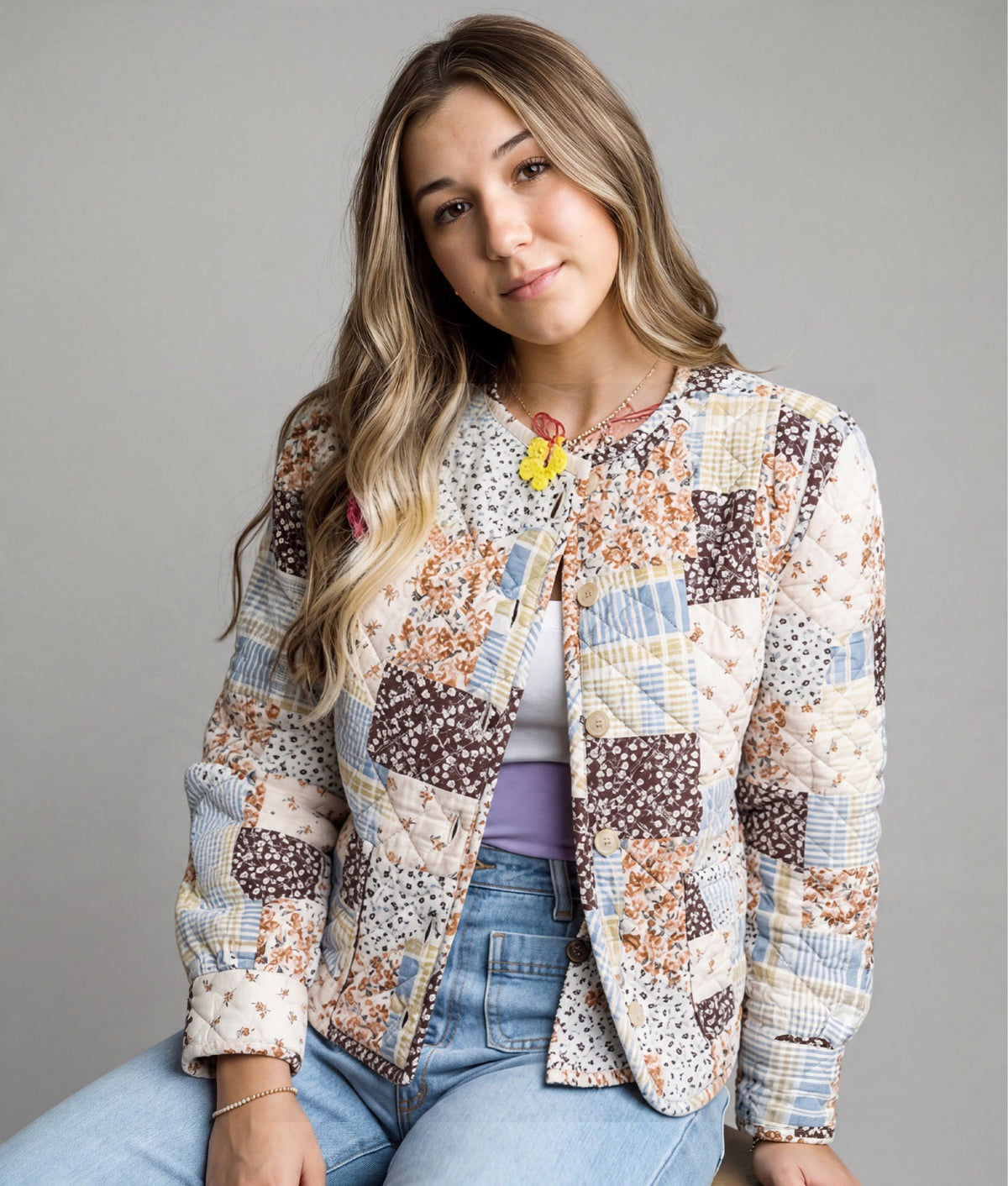 Doodlations Coffee Bar & Boutique quilted patchwork jacket with floral prints and button front on a young woman