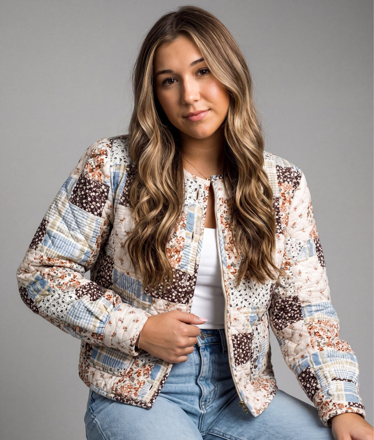 Doodlations Coffee Bar & Boutique quilted patchwork jacket with floral prints and button front on a woman