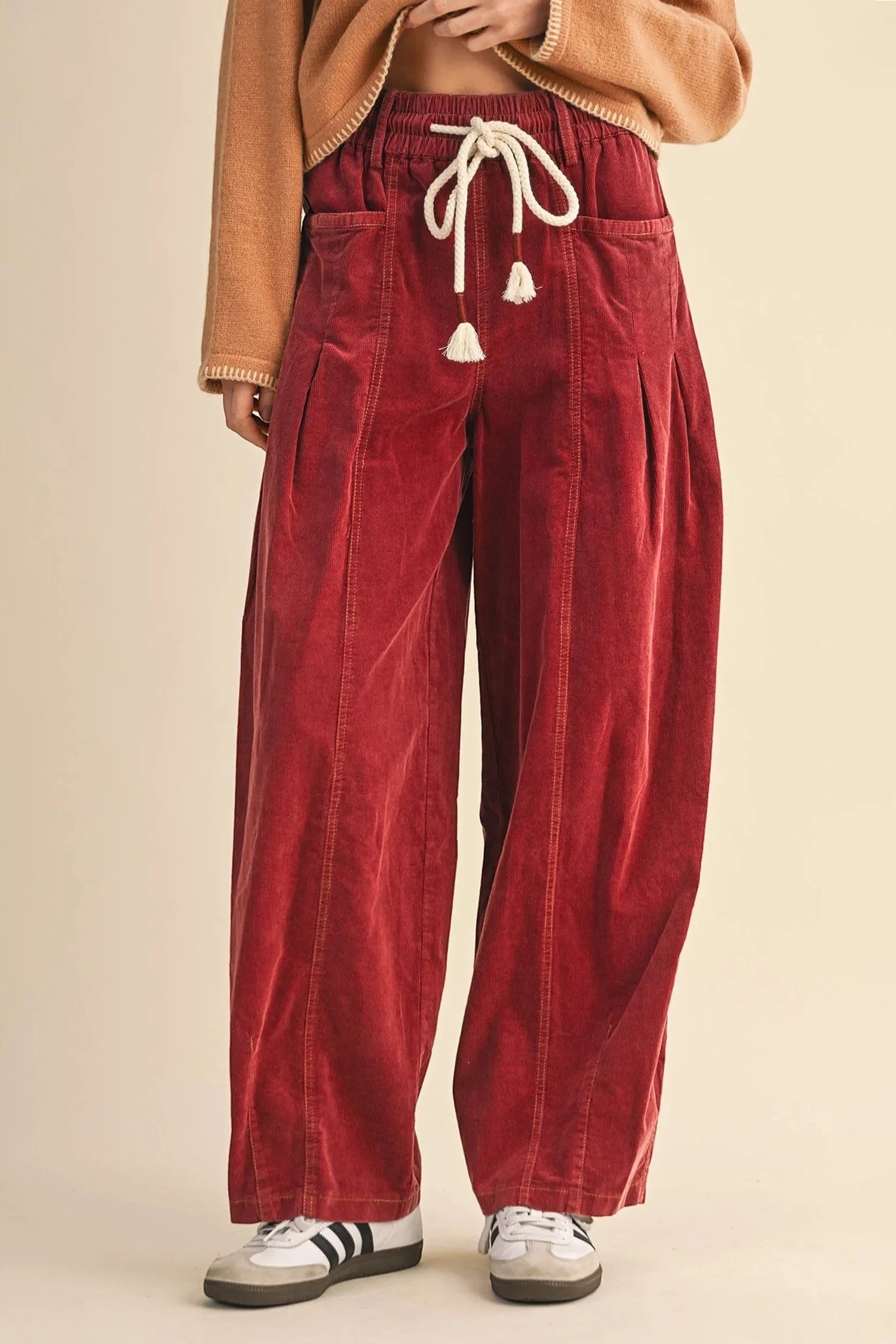 Doodlations Coffee Bar & Boutique racing red corduroy pants with an elastic drawstring waist and wide-leg fit.