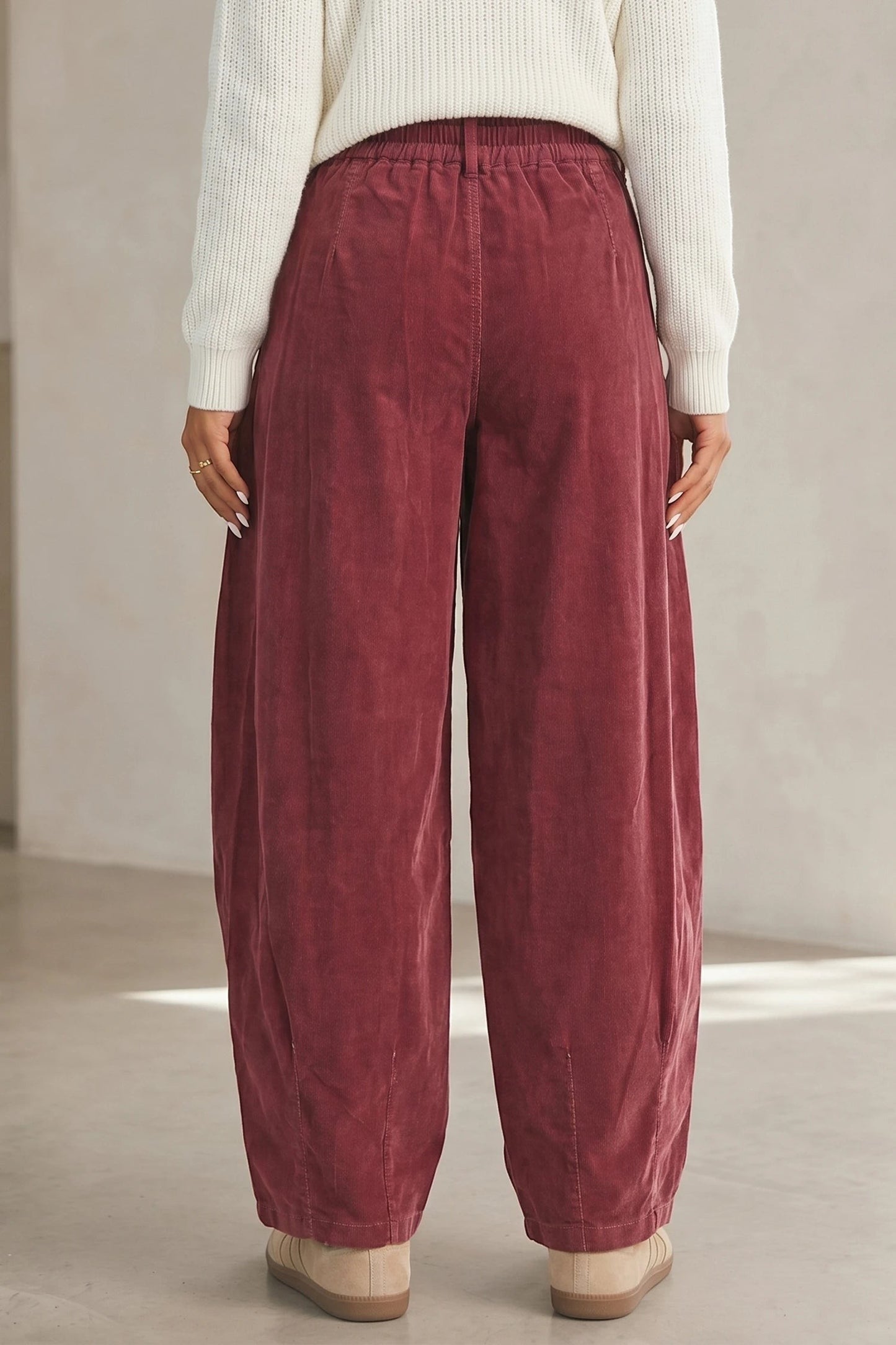 Back view of Doodlations Coffee Bar & Boutique racing red corduroy pants with an elastic drawstring waist.