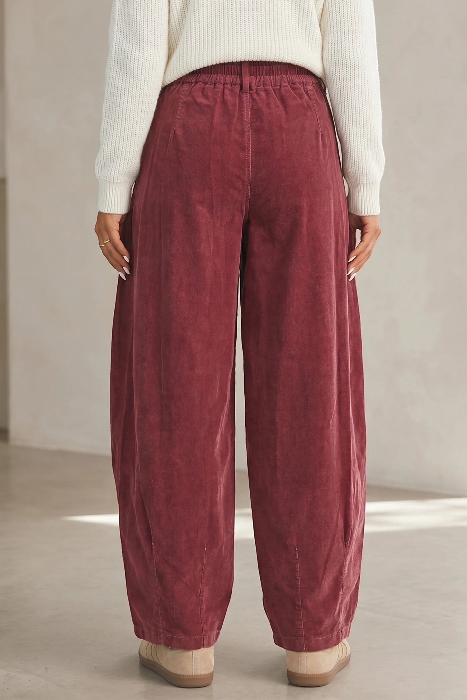Back view of Doodlations Coffee Bar & Boutique racing red corduroy pants with an elastic drawstring waist.