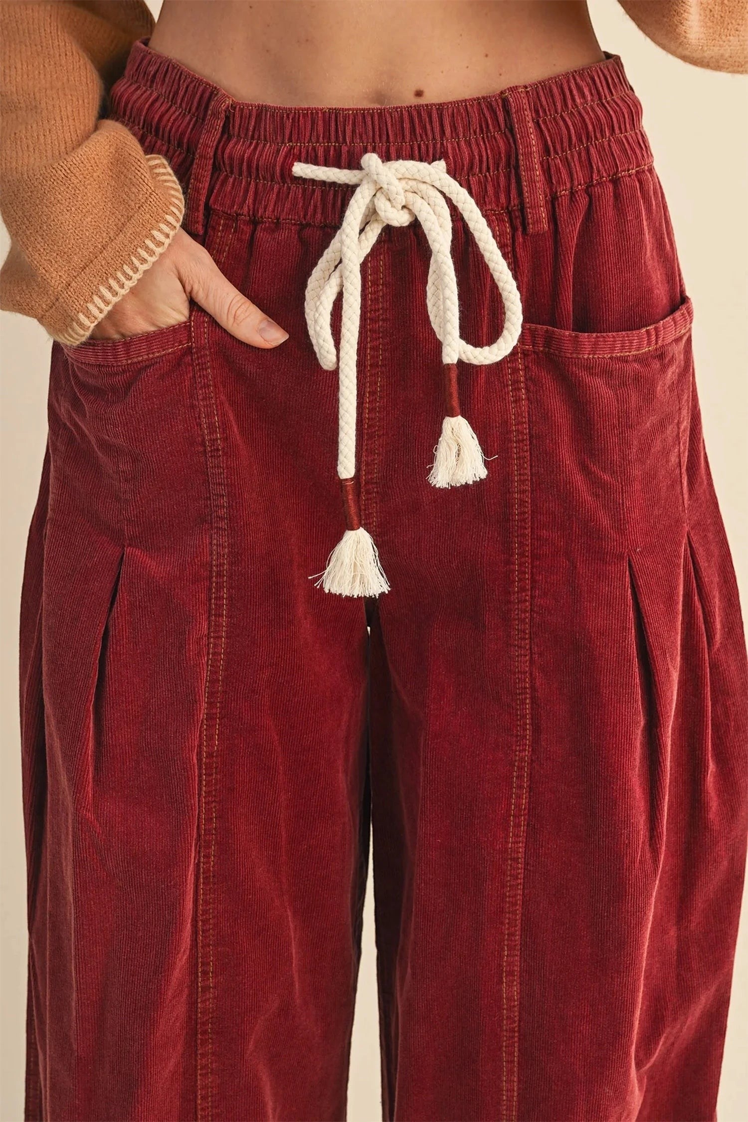 Doodlations Coffee Bar & Boutique racing red corduroy casual pants with an elastic waist and white drawstring tie.