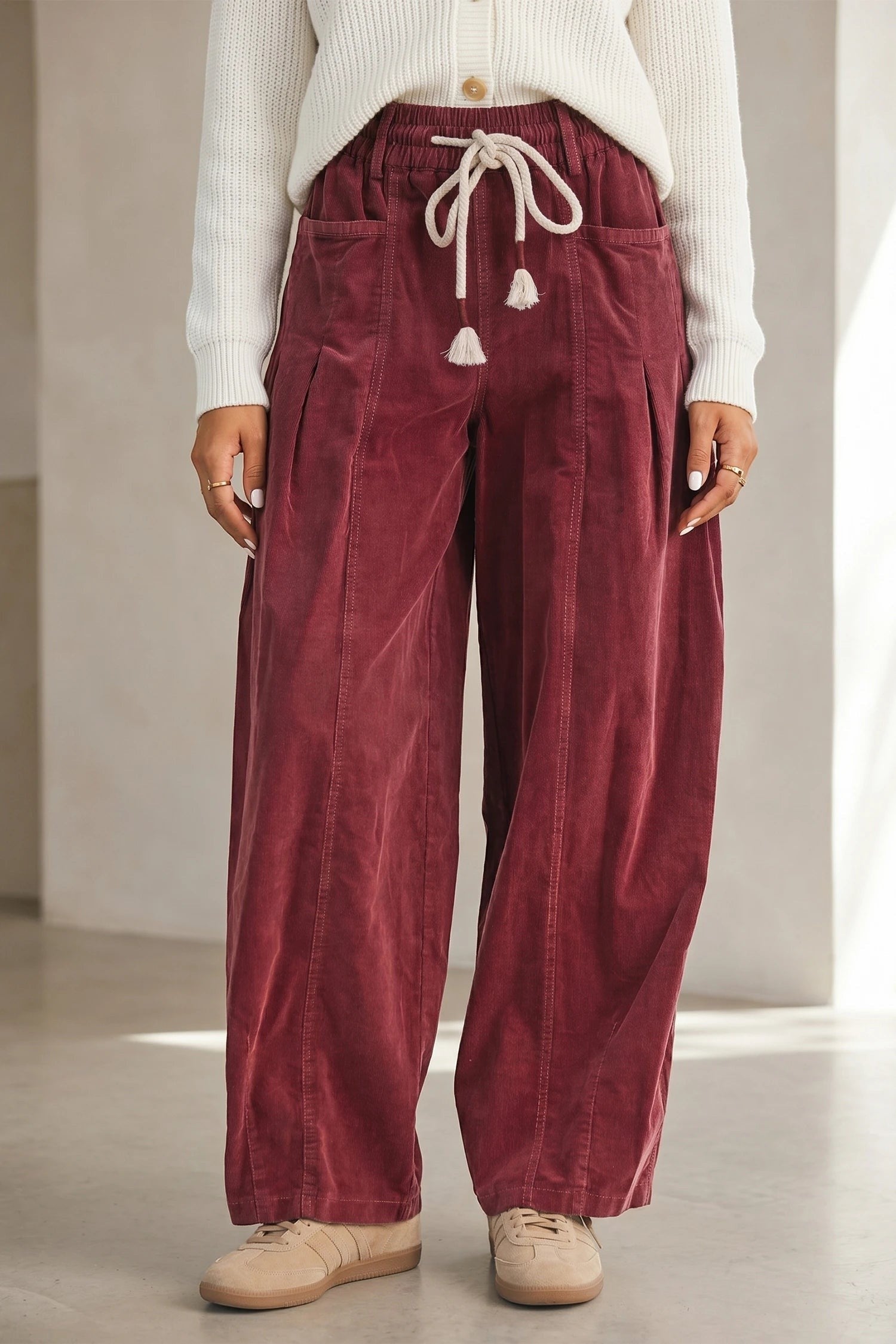 Doodlations Coffee Bar & Boutique racing red corduroy pants with an elastic drawstring waist and wide-leg fit.