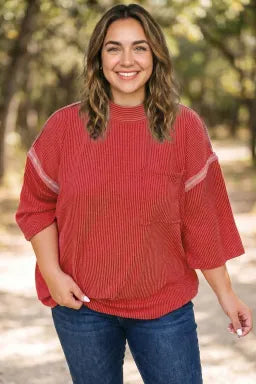 Doodlations Coffee Bar & Boutique fiery red ribbed tunic with round neck, bracelet sleeves, and chest pocket.