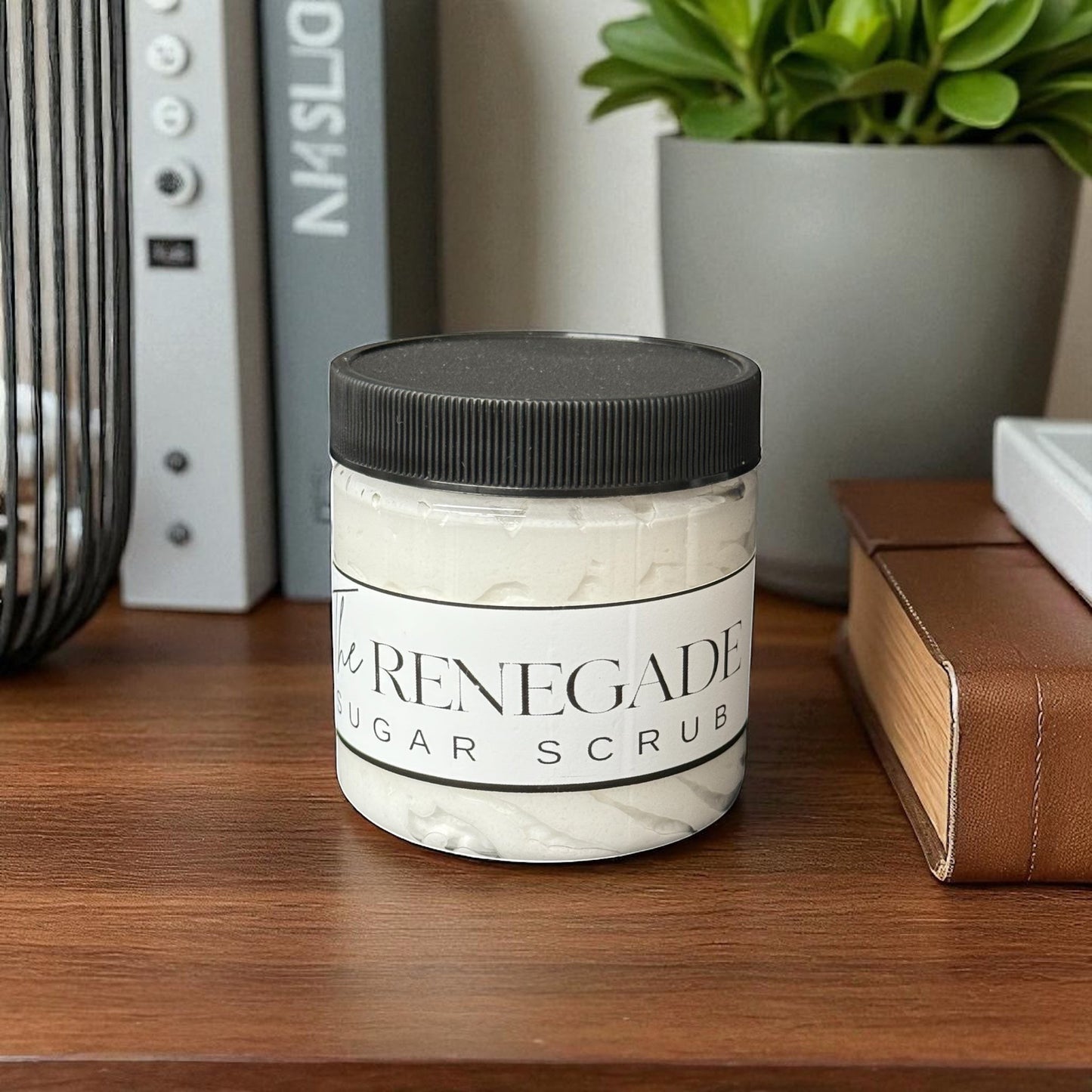 Doodlations Coffee Bar & Boutique The Renegade Men's Sugar Scrub in a clear jar with a black lid. White scrub with a sandalwood and musk scent.