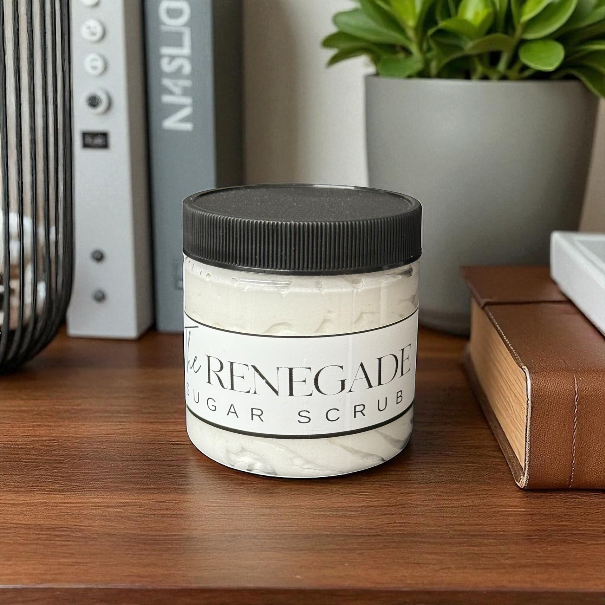 Doodlations Coffee Bar & Boutique The Renegade Men's Sugar Scrub in a clear jar with a black lid. White scrub with a sandalwood and musk scent.