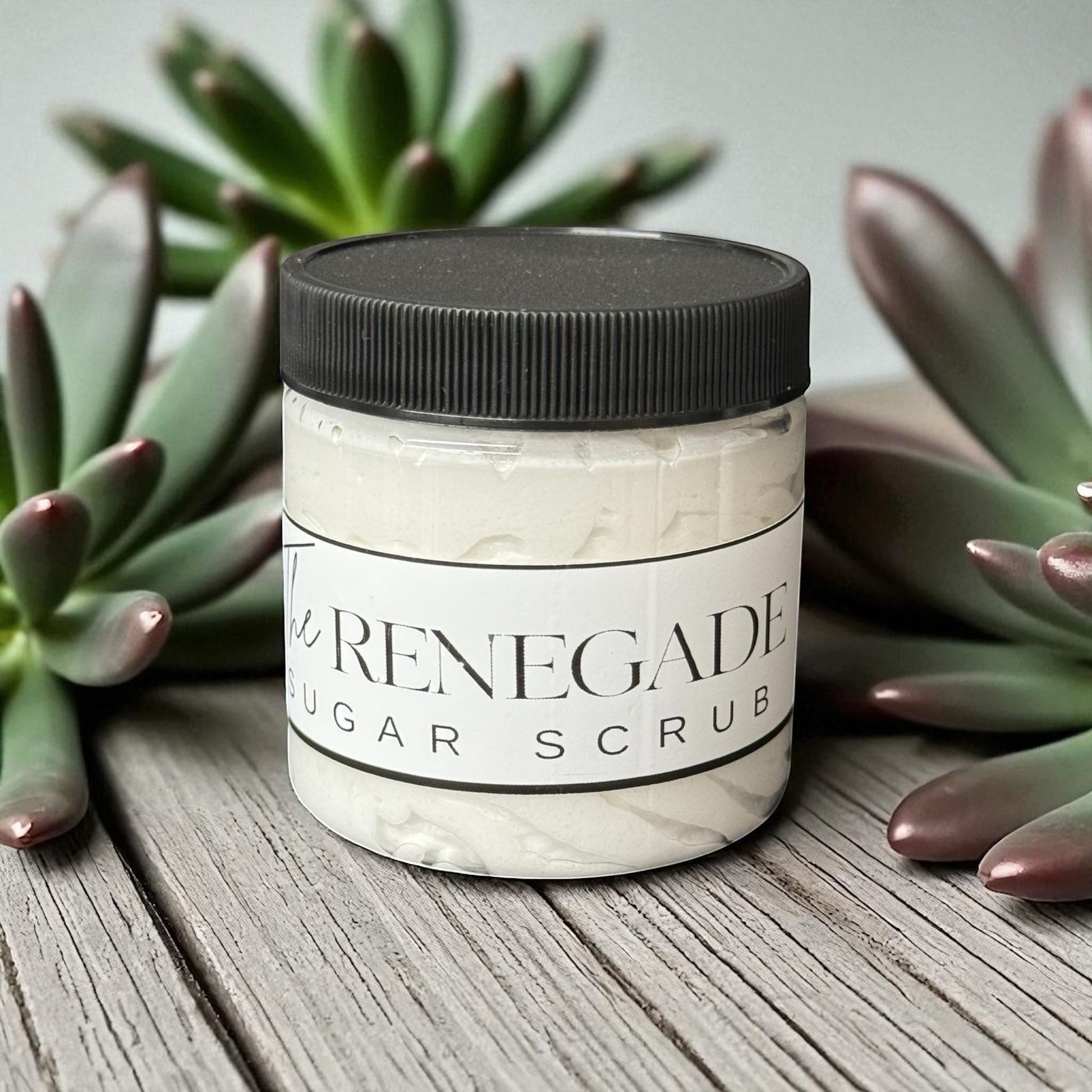 Doodlations Coffee Bar & Boutique The Renegade Men's Sugar Scrub in a clear jar with a black lid, featuring a sandalwood and musk scent.