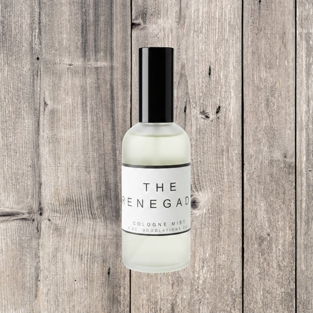 Doodlations Coffee Bar & Boutique The Renegade luxury fine mist perfume in a clear glass bottle with black cap.