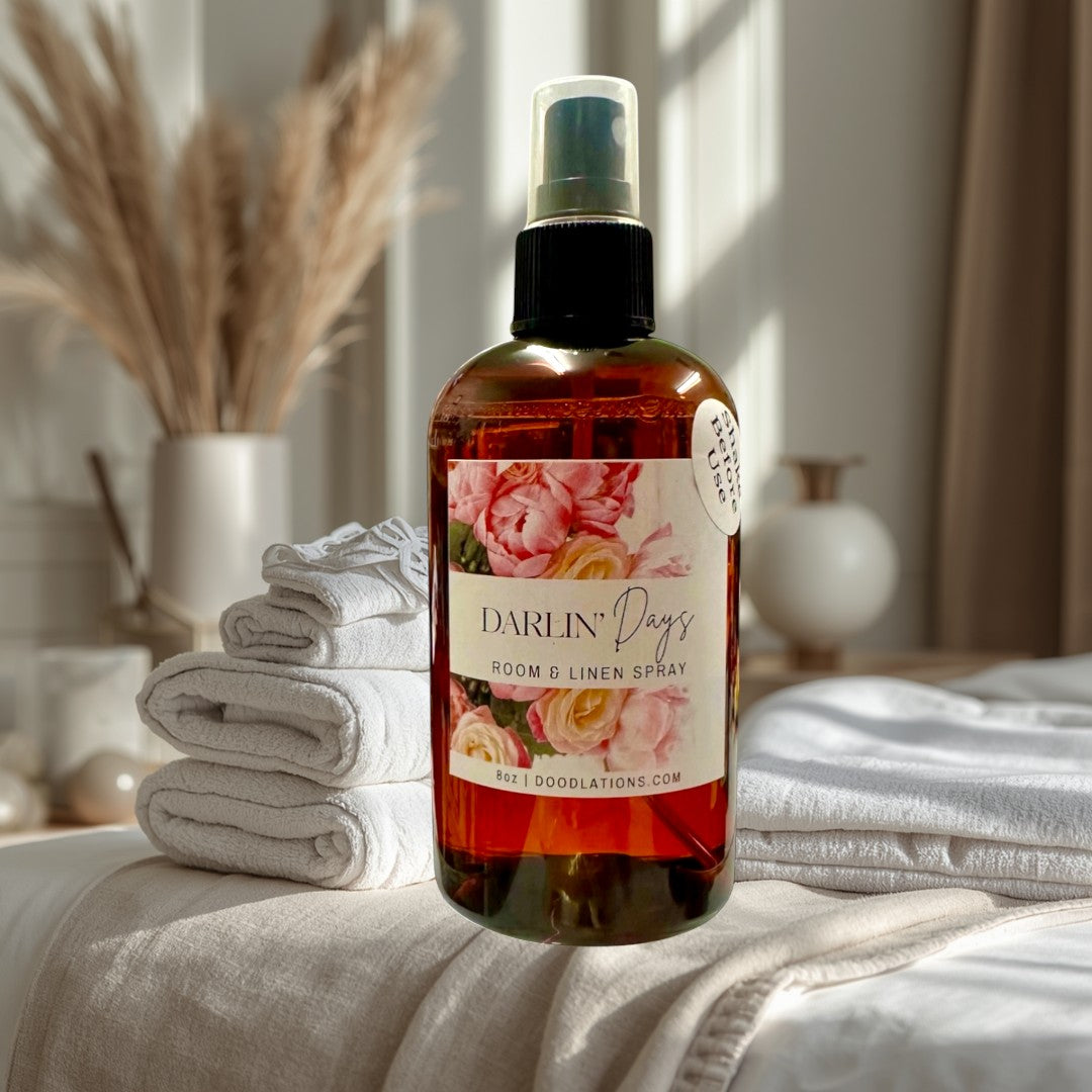 Doodlations Coffee Bar & Boutique Darlin' Days Room & Linen Spray with floral label. Amber glass bottle with spray top.