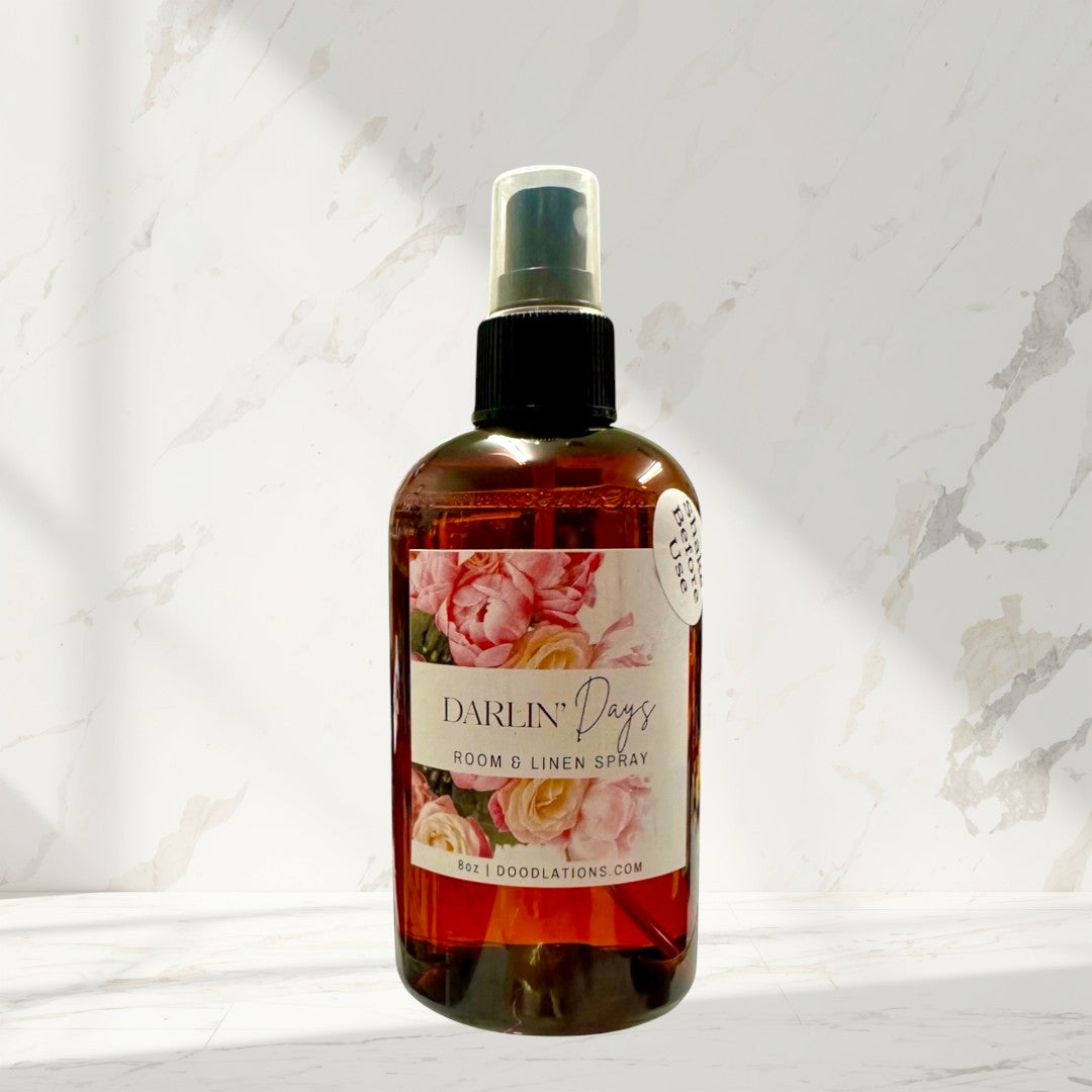 Doodlations Coffee Bar & Boutique Darlin' Days Room & Linen Spray with floral label. Amber glass bottle with spray top.