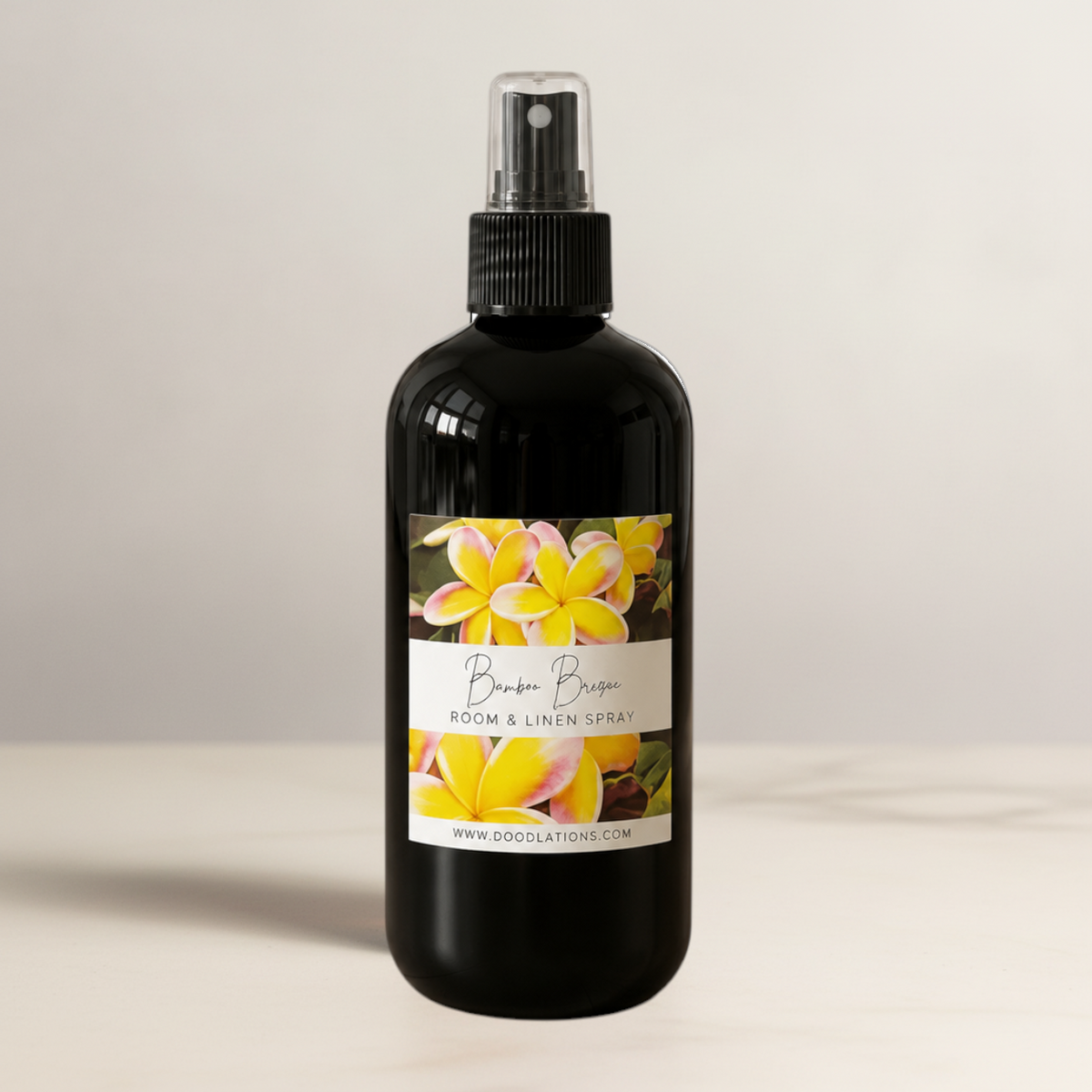 Doodlations Coffee Bar & Boutique Bum Bum room and linen spray in a black bottle with a tropical floral label