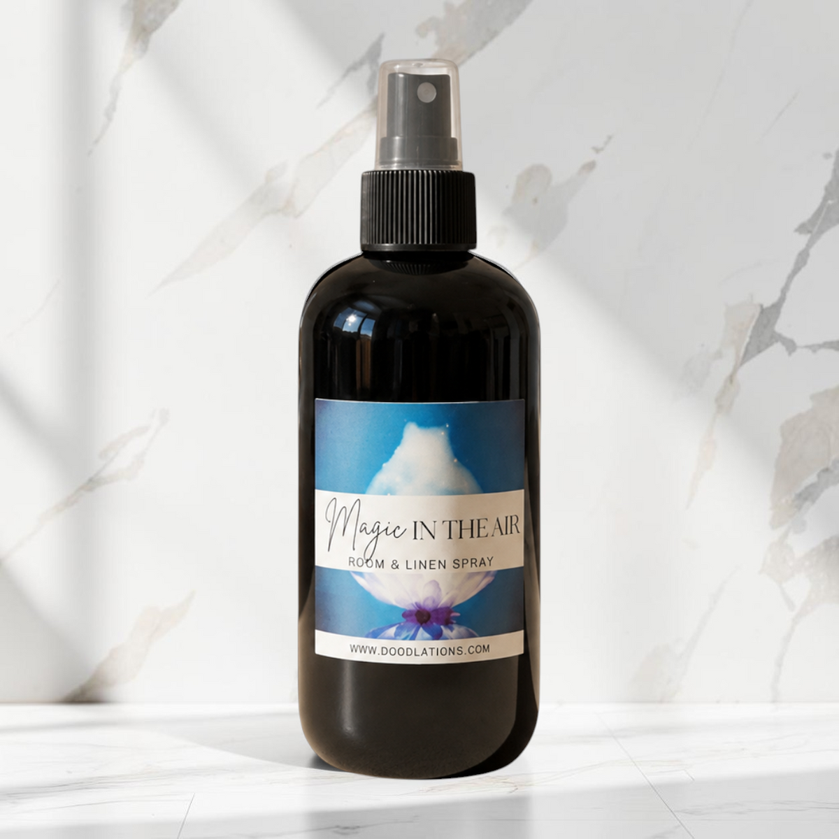 Doodlations Coffee Bar & Boutique Magic in the Air luxury room and linen spray in a black bottle with a spray nozzle.