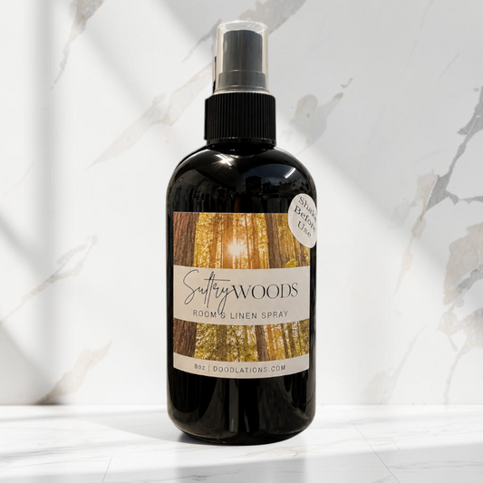 Doodlations Coffee Bar & Boutique Autumn Flannel luxury room and linen spray in a black bottle on a marble surface