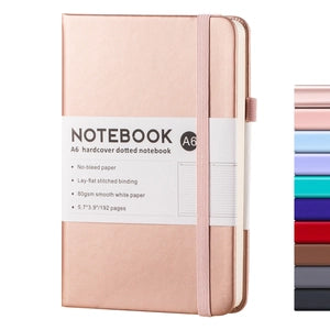 Doodlations Coffee Bar & Boutique A6 rose gold hardcover dotted journal with elastic closure and pen loop.