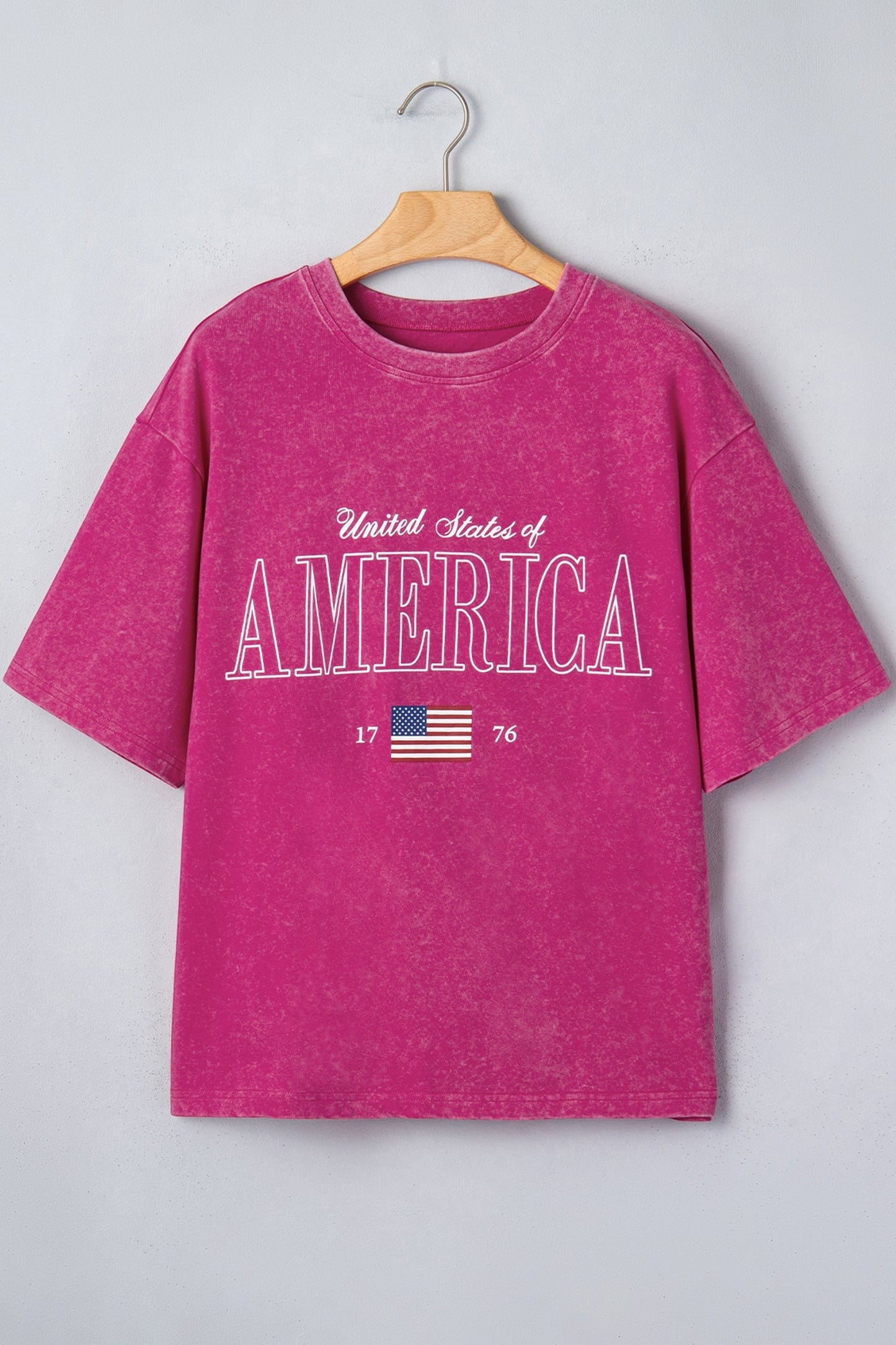 Doodlations Coffee Bar & Boutique rose red mineral wash cotton graphic tee with "AMERICA 1776" lettering and US flag.