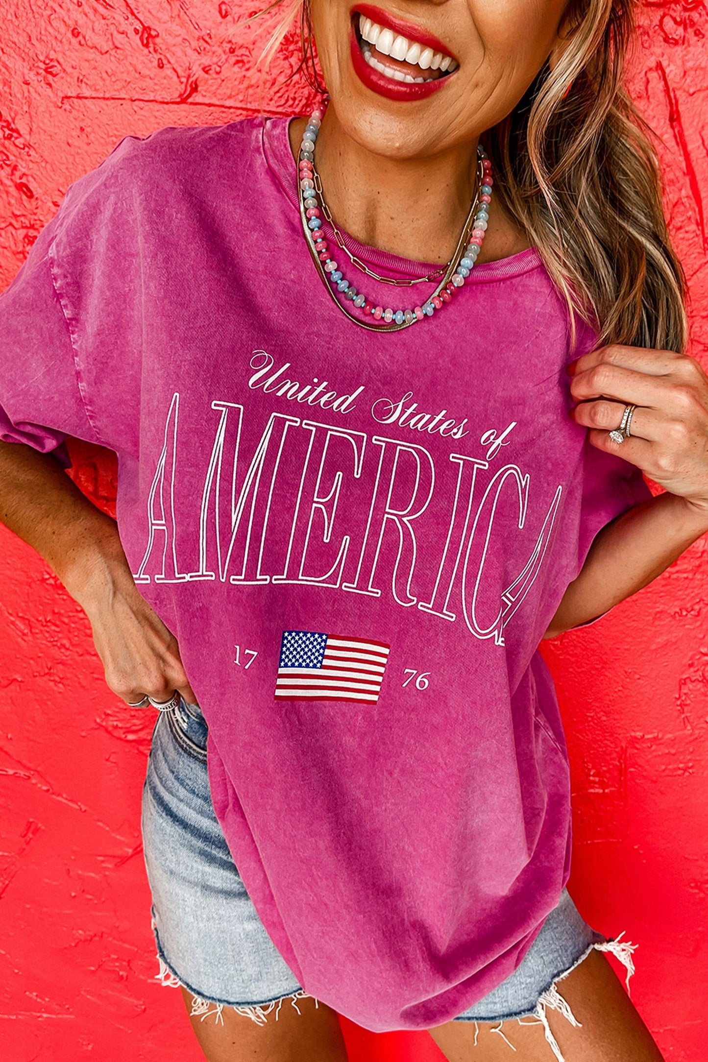 Doodlations Coffee Bar & Boutique rose red mineral wash cotton graphic tee with "United States of America" text and American flag detail.