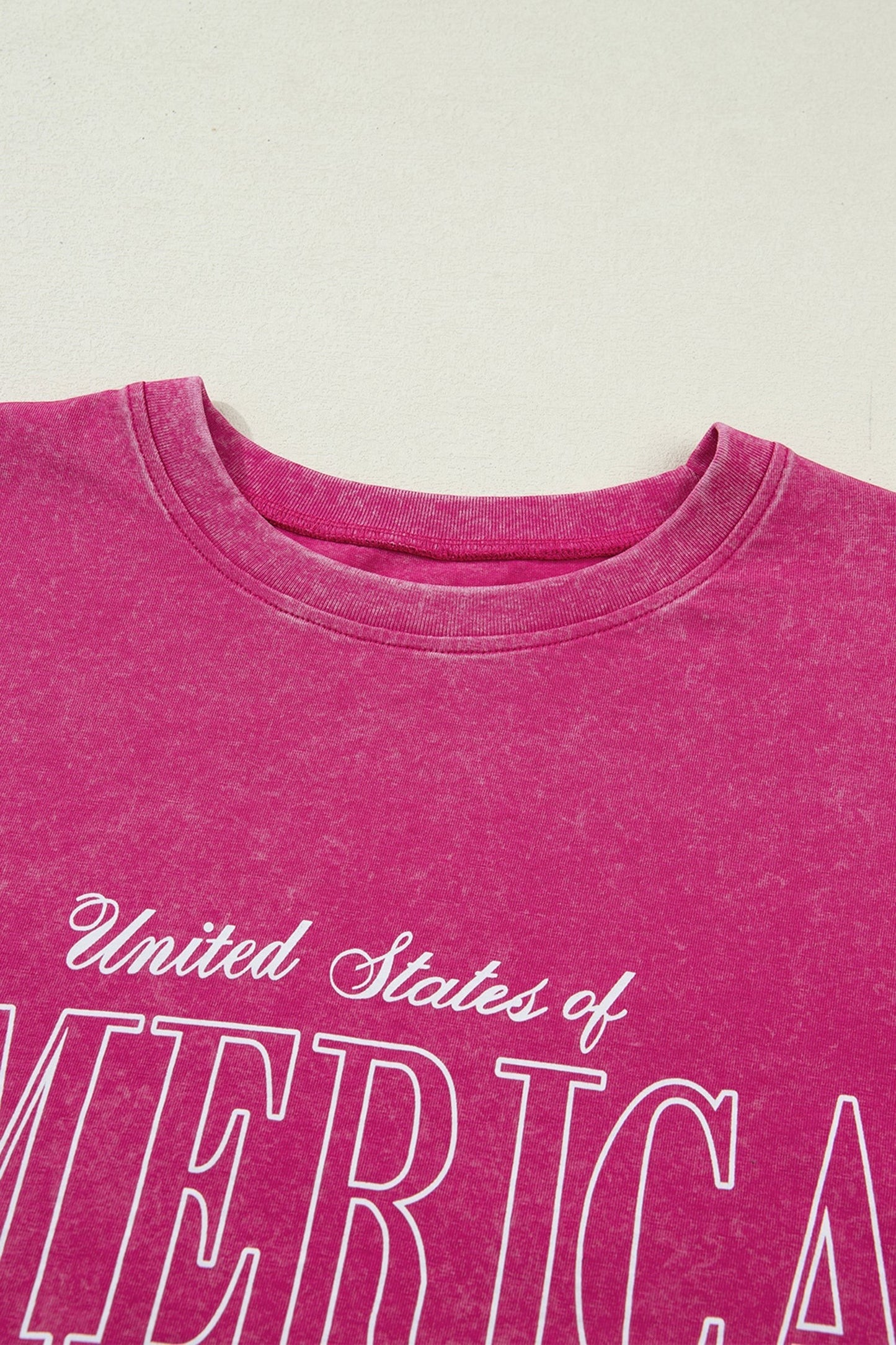 Doodlations Coffee Bar & Boutique rose red mineral wash cotton graphic tee with "AMERICA 1776" lettering.