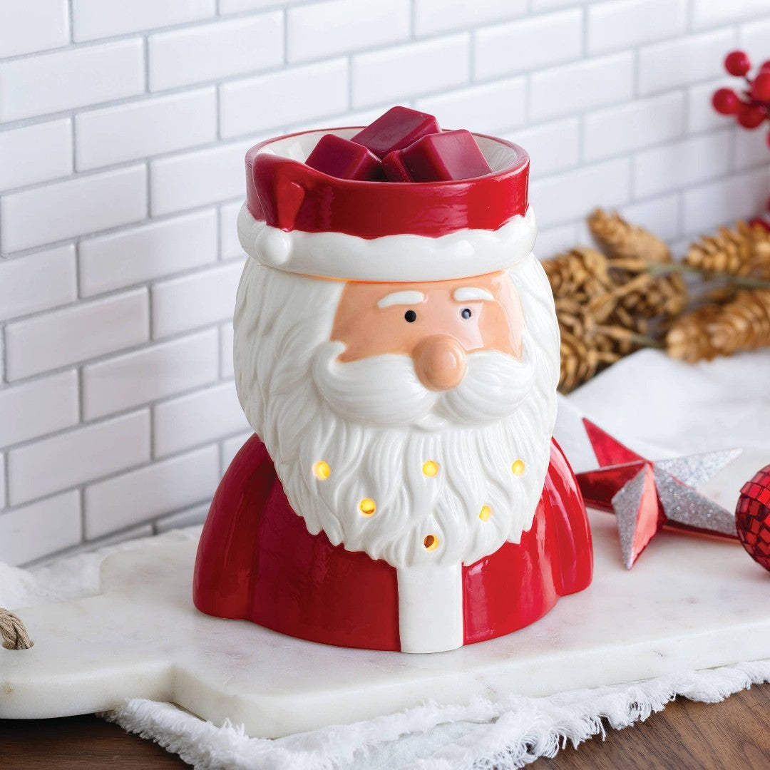Doodlations St. Nick fragrance warmer shaped like Santa Claus, with red suit and white beard, glowing warmly.