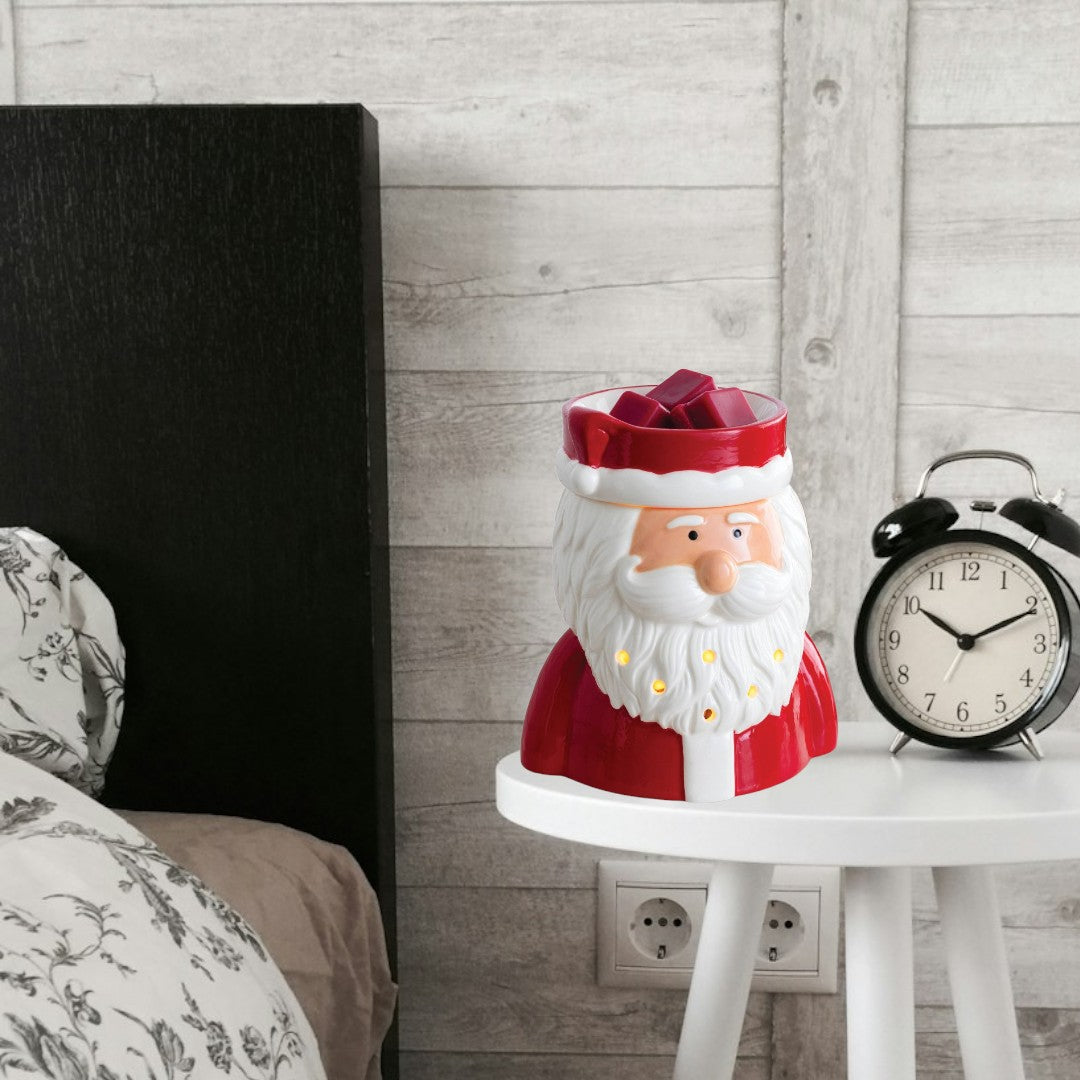 Doodlations St. Nick fragrance warmer shaped like Santa Claus, with red suit and white beard, holding red wax melts.