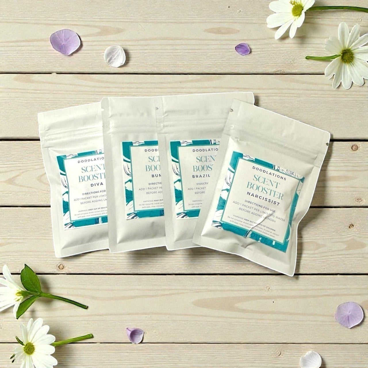 Doodlations Coffee Bar & Boutique Scent Booster Sampler Pack with four individual scent packets, each featuring teal and white floral designs.