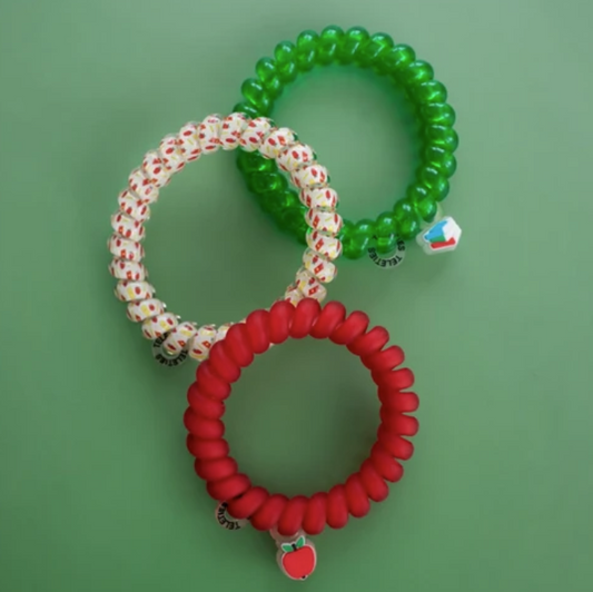 Doodlations Coffee Bar & Boutique Teleties School Days hair ties in red, green, and apple print on a green background