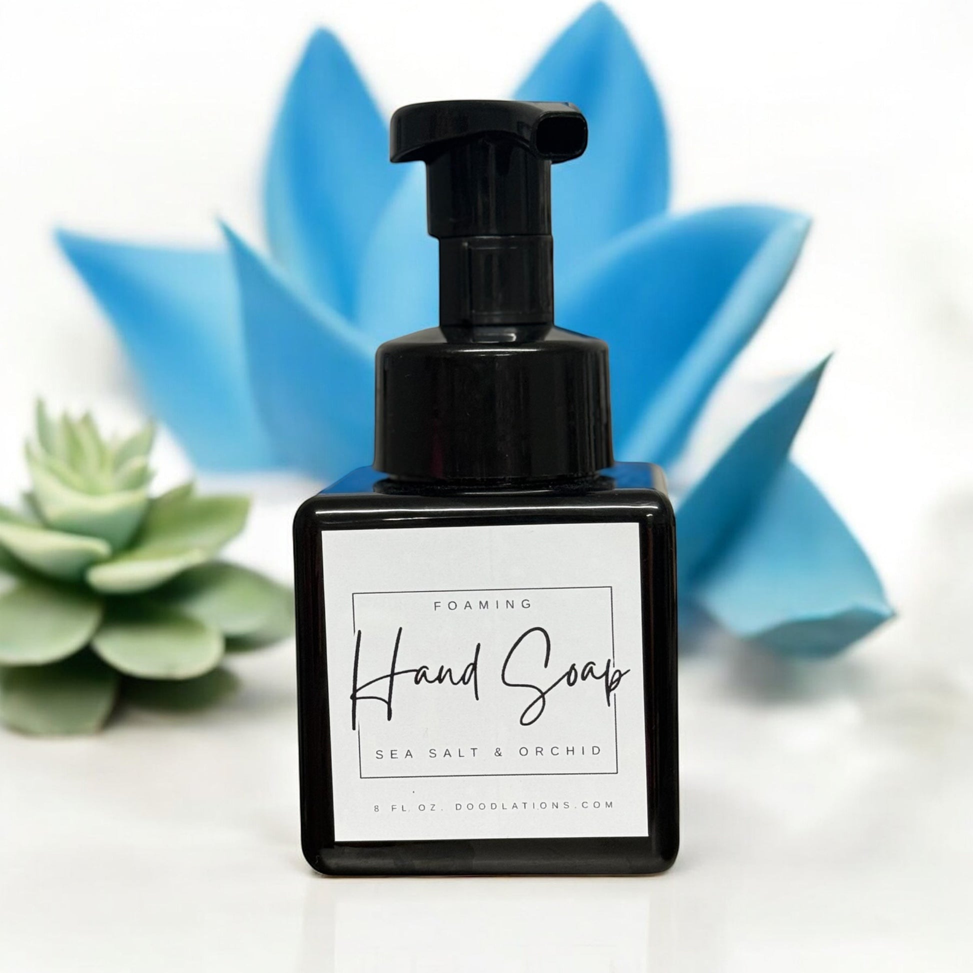 Doodlations Coffee Bar & Boutique Sea Salt & Orchid foaming hand soap in a black square bottle with a white label.