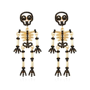 Doodlations Coffee Bar & Boutique articulated skeleton dangle earrings featuring black rhinestones on gold-tone alloy.